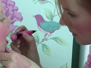 woman paints an app. 6 years old girl